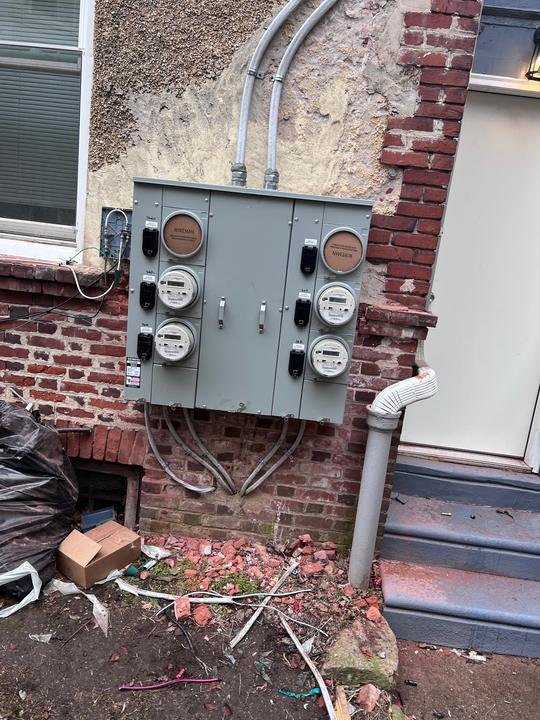 A Siemens meter bank with a service disconnect for each unit: studio, house, first, second and third floors.