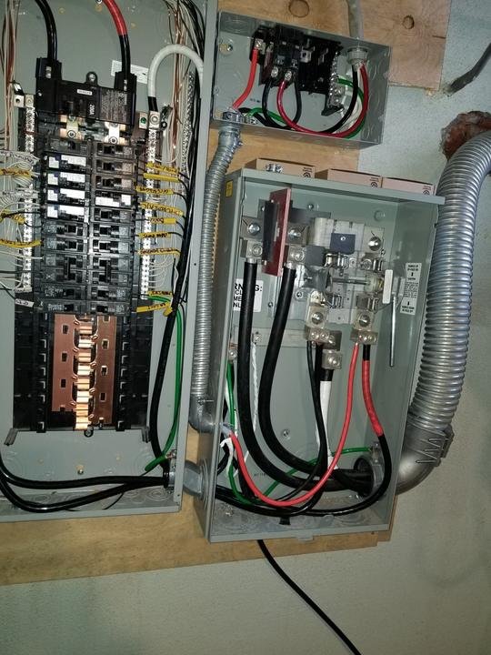 A new Siemens 200 amp panel with labeled circuits, a meter socket and a 100 amp disconnect, wired in flexible metal conduit.