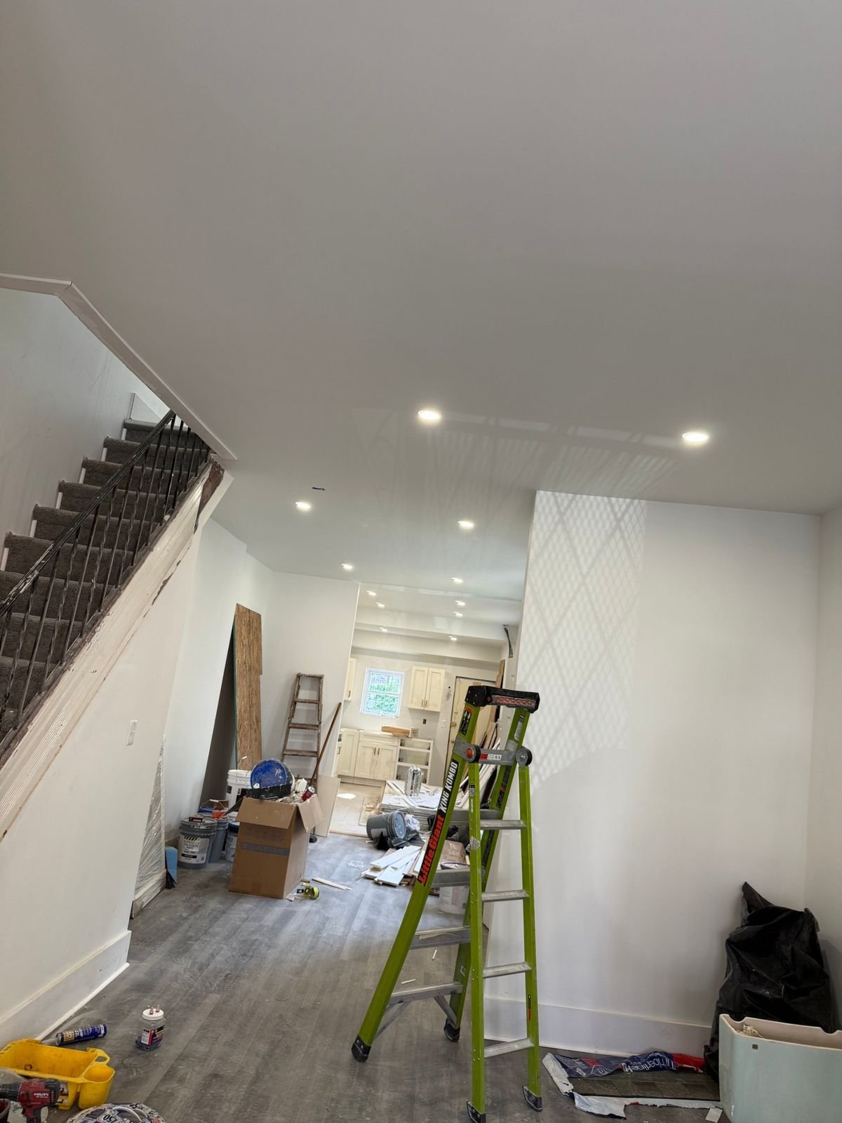 LED recessed downlights installed along a hallway and stair in a Philadelphia rowhome renovation.